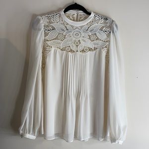 Open-back off-white blouse with lace detail